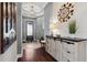 Well-lit foyer with hardwood floors, an accent table, and elegant decorations at 10406 Eastwood Dr, Bradenton, FL 34211