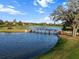 Scenic view of the golf course showcasing a bridge over a tranquil water hazard and mature trees at 10406 Eastwood Dr, Bradenton, FL 34211