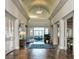 Elegant hallway featuring hardwood floors, arched ceiling, and views into dining area at 10406 Eastwood Dr, Bradenton, FL 34211