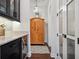 Hallway featuring wood floors, elegant lighting, and stylish storage at 10406 Eastwood Dr, Bradenton, FL 34211