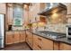Gourmet kitchen with stainless steel appliances, granite counters, and abundant storage at 10406 Eastwood Dr, Bradenton, FL 34211