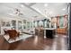 A spacious and well-lit living room with hardwood floors, an open layout and a modern kitchen at 10406 Eastwood Dr, Bradenton, FL 34211