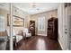 Bright living room with hardwood floors, plantation shutters, and two chairs surrounding the artwork at 10406 Eastwood Dr, Bradenton, FL 34211