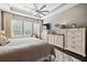 Comfortable main bedroom featuring tray ceilings, a ceiling fan, and ample storage space at 10406 Eastwood Dr, Bradenton, FL 34211
