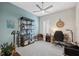 Home office space featuring neutral carpet, blue accent wall, bookshelf, desk, and a window with shutters at 10406 Eastwood Dr, Bradenton, FL 34211