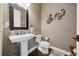 Tastefully decorated powder room with pedestal sink, decorative mirror, and stylish wall accents at 10406 Eastwood Dr, Bradenton, FL 34211