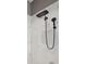Stylish walk-in shower featuring black fixtures and white marble-patterned tile at 10406 Eastwood Dr, Bradenton, FL 34211