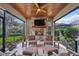 Enclosed sun room with a fireplace, stone surround and wood ceiling at 10406 Eastwood Dr, Bradenton, FL 34211