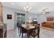 Bright dining room with a wooden table and chairs and a view of the living room and patio at 1213 Grantham Dr, Sarasota, FL 34234