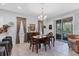 Dining area with a wooden table, chandelier, and sliding doors to an outdoor patio at 1213 Grantham Dr, Sarasota, FL 34234