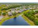 Aerial view of homes with lake access, mature trees, and beautiful landscaping in a peaceful community setting at 12211 Lavender Loop, Bradenton, FL 34212