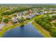 Aerial view shows the lake, trees and houses in this residential neighborhood at 12211 Lavender Loop, Bradenton, FL 34212