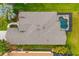 Aerial view showcases a home's roof, screened pool, lush landscaping, and inviting outdoor living space at 12211 Lavender Loop, Bradenton, FL 34212