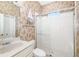 Bathroom featuring a large glass shower, sink, and stylish wallpaper design at 12211 Lavender Loop, Bradenton, FL 34212