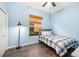 Light blue bedroom features wood-look flooring, a ceiling fan, and a twin bed at 12211 Lavender Loop, Bradenton, FL 34212