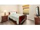 Cozy bedroom with a bed, bedside table, wood floors, dresser and a window at 12211 Lavender Loop, Bradenton, FL 34212