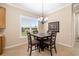 Bright dining area with views of the backyard and space for four, next to the kitchen at 12211 Lavender Loop, Bradenton, FL 34212