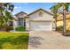 Charming single-Gathering home boasts a well-manicured lawn, neutral stucco and a wide driveway, creating curb appeal at 12211 Lavender Loop, Bradenton, FL 34212
