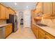 Spacious kitchen with stainless steel appliances, wood cabinets, and ample countertop space at 12211 Lavender Loop, Bradenton, FL 34212