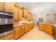 Charming kitchen with stainless steel appliances, wooden cabinets, and tile flooring at 12211 Lavender Loop, Bradenton, FL 34212