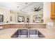 Beautiful kitchen sink with granite countertops and stainless steel faucet with view to living room at 12211 Lavender Loop, Bradenton, FL 34212