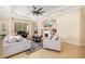 Spacious living room featuring a fireplace, large ceiling fan, and comfortable seating at 12211 Lavender Loop, Bradenton, FL 34212