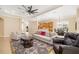 Open-concept living area with kitchen access offers a large sofa, breakfast bar, and neutral tile floors at 12211 Lavender Loop, Bradenton, FL 34212