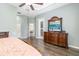 This spacious main bedroom has neutral walls, a ceiling fan and a large dresser with a TV at 12211 Lavender Loop, Bradenton, FL 34212