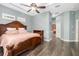 Spacious main bedroom boasts wood floors, stylish furnishings, and an en-suite bathroom at 12211 Lavender Loop, Bradenton, FL 34212