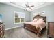 Relaxing main bedroom featuring a decorative ceiling fan, wood floors, and a large window at 12211 Lavender Loop, Bradenton, FL 34212