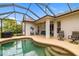 Enjoy this backyard patio with a screened-in pool and outdoor seating at 12211 Lavender Loop, Bradenton, FL 34212