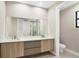Modern bathroom with double vanity, large mirror, and contemporary fixtures at 12495 Patsy Ave, Port Charlotte, FL 33981