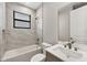 Modern bathroom with tiled walls, soaking tub, and stylish vanity at 12495 Patsy Ave, Port Charlotte, FL 33981