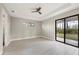 Spacious bedroom with tray ceiling, recessed lighting, and sliding glass doors to the backyard at 12495 Patsy Ave, Port Charlotte, FL 33981