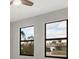 Bedroom featuring natural light from dual windows and serene neighborhood views at 12495 Patsy Ave, Port Charlotte, FL 33981