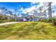 Beautiful view of single Gathering home on a bright sunny day with green yard at 12495 Patsy Ave, Port Charlotte, FL 33981