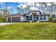 Beautiful single-story home featuring a three-car garage and a well-manicured lawn at 12495 Patsy Ave, Port Charlotte, FL 33981