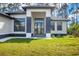 Inviting entrance with stone accents and a modern black framed front door at 12495 Patsy Ave, Port Charlotte, FL 33981