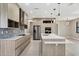 Modern kitchen with stainless steel appliances, white countertops, and wood-grain cabinetry at 12495 Patsy Ave, Port Charlotte, FL 33981