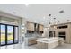 Stylish kitchen featuring a large island with a waterfall countertop and modern appliances at 12495 Patsy Ave, Port Charlotte, FL 33981