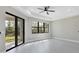 Main bedroom features gray-toned wood floors, a ceiling fan, and large windows at 12495 Patsy Ave, Port Charlotte, FL 33981