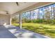 Covered patio overlooking lush backyard with well-maintained lawn and mature trees at 12495 Patsy Ave, Port Charlotte, FL 33981