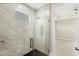 Glass-enclosed shower featuring marble tile and modern fixtures at 12495 Patsy Ave, Port Charlotte, FL 33981