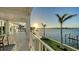 Expansive porch with water views, palm trees, and elegant railings at 1300 Tangier Way, Sarasota, FL 34239
