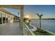 Back porch features a pool right on the water, palm trees, and gorgeous sunset views at 1300 Tangier Way, Sarasota, FL 34239