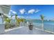 Balcony with white railing and tile floors overlooking a bay and bridge at 1300 Tangier Way, Sarasota, FL 34239