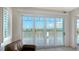 Sliding glass doors lead to a balcony with stunning water views at 1300 Tangier Way, Sarasota, FL 34239