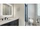 Modern bathroom with a frameless glass shower, lighted mirror, sleek vanity, and wooden floors at 1300 Tangier Way, Sarasota, FL 34239