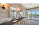 Bathroom featuring dual sinks, wood-look tile, and great natural light at 1300 Tangier Way, Sarasota, FL 34239