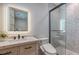 Modern bathroom featuring hexagon tile shower, lighted mirror, and custom vanity at 1300 Tangier Way, Sarasota, FL 34239